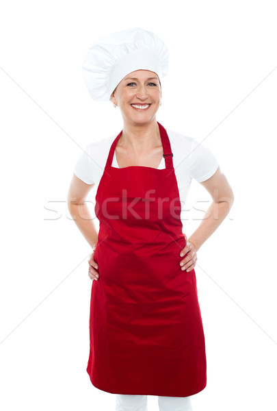 Female cook posing with hands on her waist Stock photo © stockyimages
