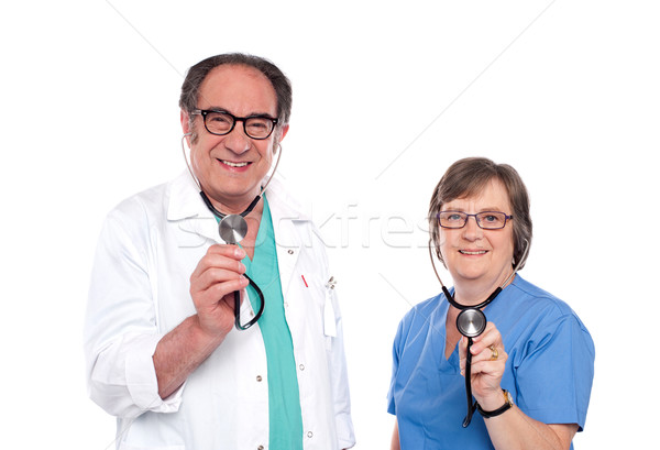 Sorridente masculino feminino médicos posando Foto stock © stockyimages