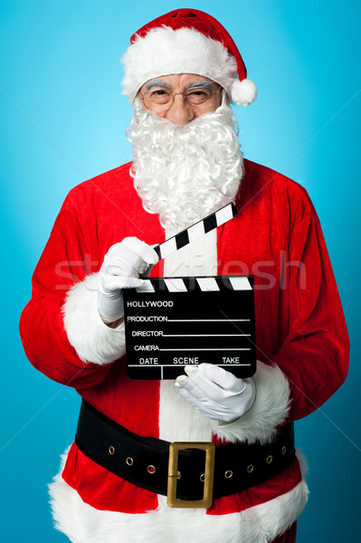 Bespectacled Santa holding a clapperboard Stock photo © stockyimages