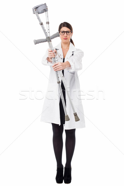Medical expert holding up the crutches Stock photo © stockyimages