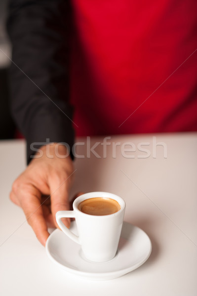Hands of waiter serving a cup of cappucino Stock photo © stockyimages