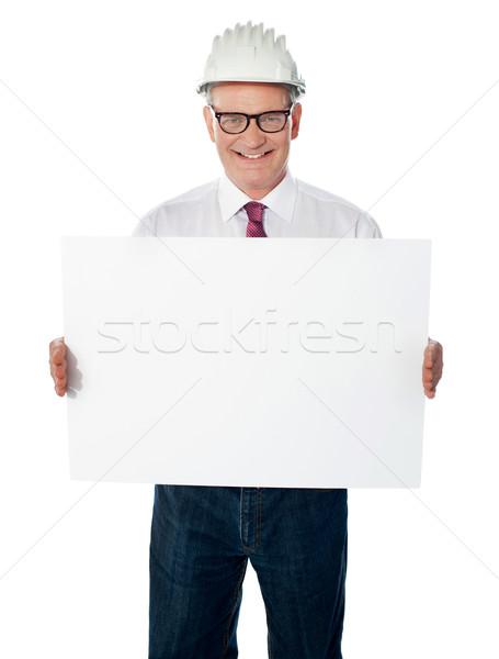 Senior architect holding blank billboard Stock photo © stockyimages