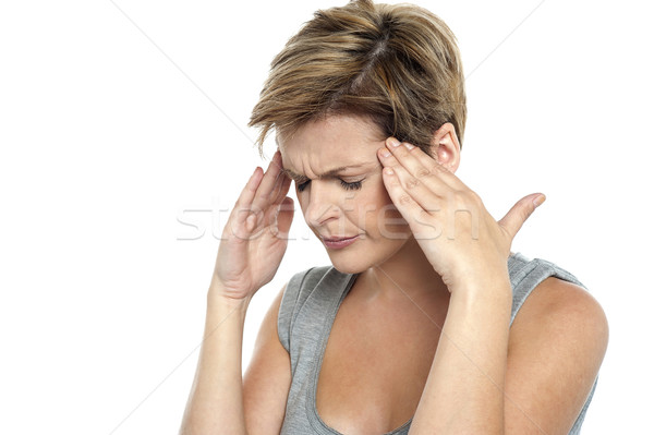 Woman having headache. Holding her head Stock photo © stockyimages