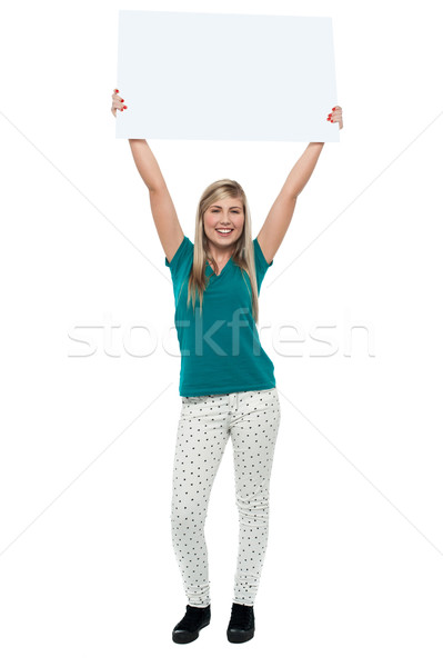 Woman holding ad board above her head Stock photo © stockyimages
