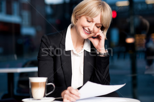 Female reviewing business report in cafe Stock photo © stockyimages