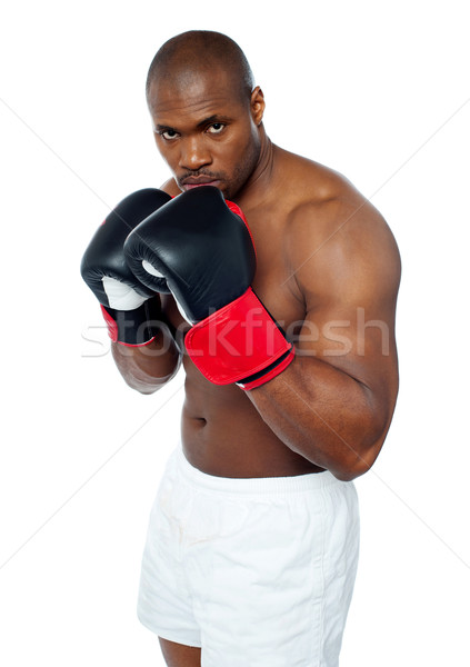 Shirtless african boxer aiming to punch you Stock photo © stockyimages