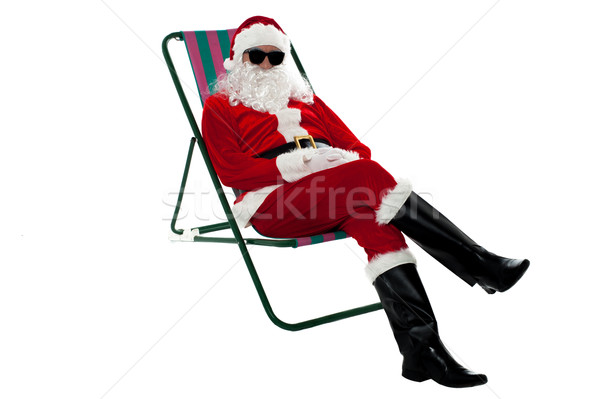 Santa wearing shades and striking stylish pose Stock photo © stockyimages