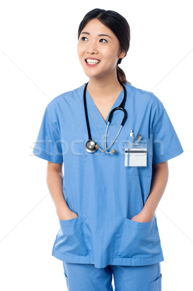 Feminino médico uniforme jovem pensando Foto stock © stockyimages