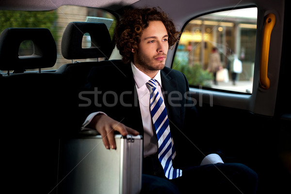 Handsome businessman inside taxi cab Stock photo © stockyimages