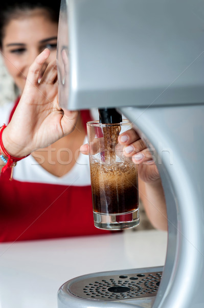 Girl filling glass with chocolate shake Stock photo © stockyimages