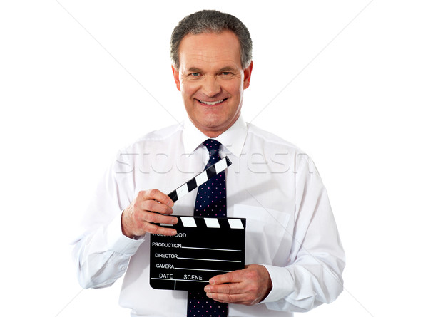 Aged corporate male holding clapperboard Stock photo © stockyimages