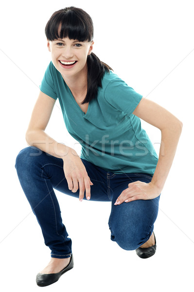 Good looking female model in squatting posture Stock photo © stockyimages