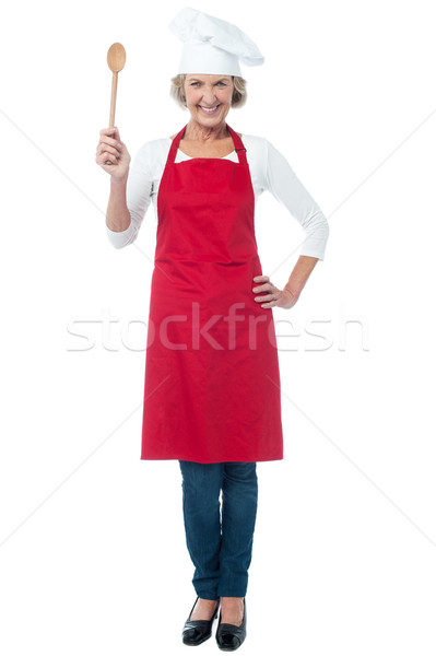 Happy aged chef holding wooden spoon Stock photo © stockyimages