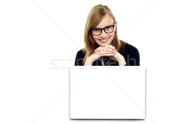 Charming schoolgirl sitting with her laptop open Stock photo © stockyimages