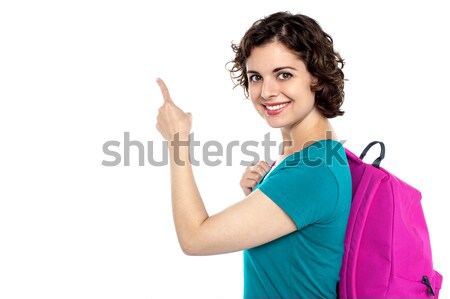 Pretty student indicating towards copy space area Stock photo © stockyimages