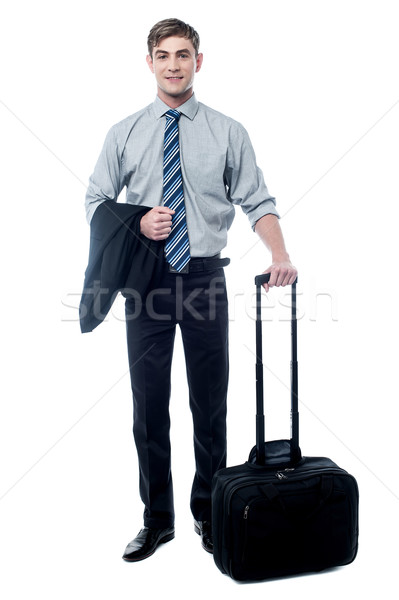 Young businessman posing with trolley bag Stock photo © stockyimages