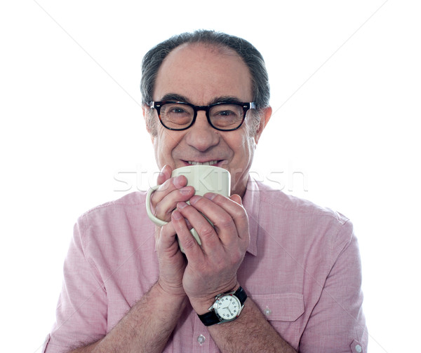 Senior man smiling and enjoying coffee Stock photo © stockyimages