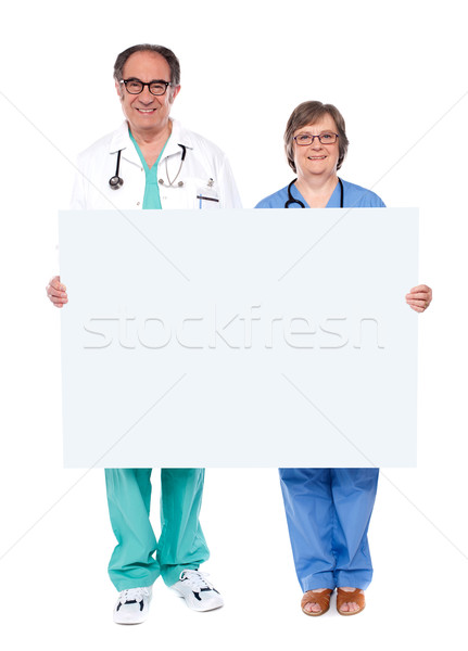 Medical professionals showing blank billboard Stock photo © stockyimages