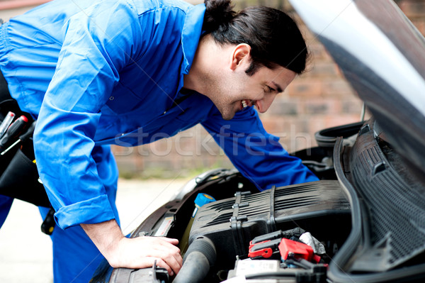 Mechanic checking under the car engine Stock photo © stockyimages
