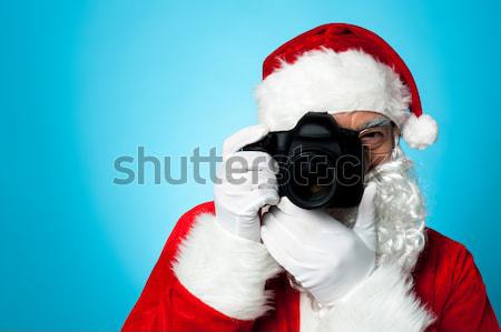 Aged Santa adjusting camera lens before click Stock photo © stockyimages