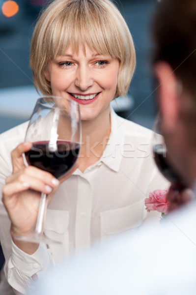 Couple sipping red wine and cherishing memories Stock photo © stockyimages