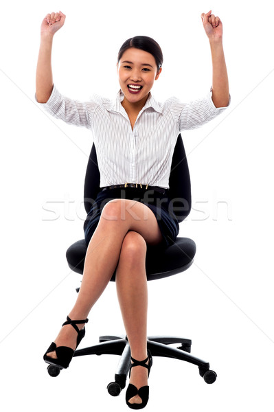 Joyous female raising arms in excitement Stock photo © stockyimages
