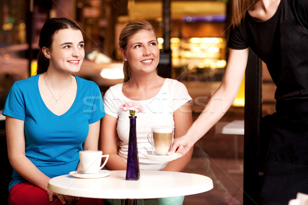 Two beautiful young girls at coffee shop Stock photo © stockyimages