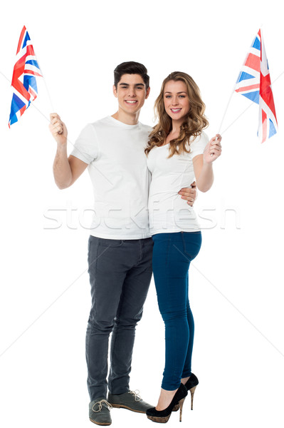 Cheerful couple waving the British flag Stock photo © stockyimages