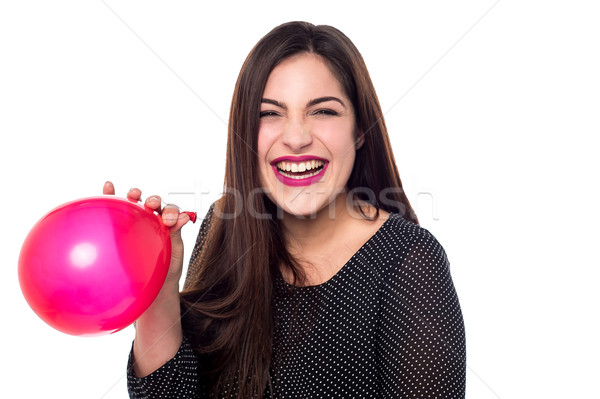 Cheerful woman with red balloon Stock photo © stockyimages