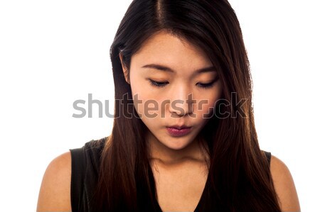 Sad young girl looking downwards Stock photo © stockyimages
