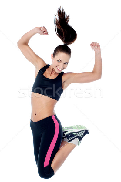 Młoda dziewczyna odzież sportowa skoki radości dziewczyna Zdjęcia stock © stockyimages