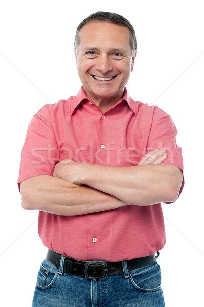 Hombre guapo posando armas doblado casual altos Foto stock © stockyimages