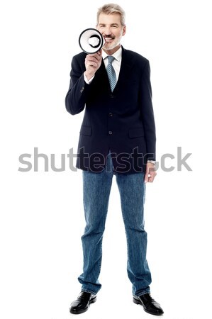 Smiling businessman holding a megaphone Stock photo © stockyimages