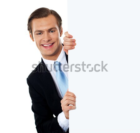 Wskazując młodych uśmiechnięty człowiek tle Zdjęcia stock © stockyimages