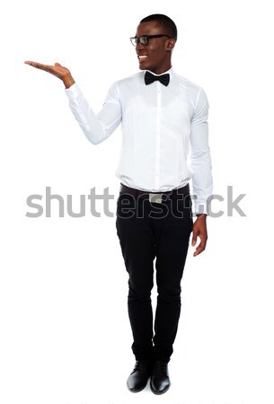 Smiling isolated man presenting copyspace Stock photo © stockyimages