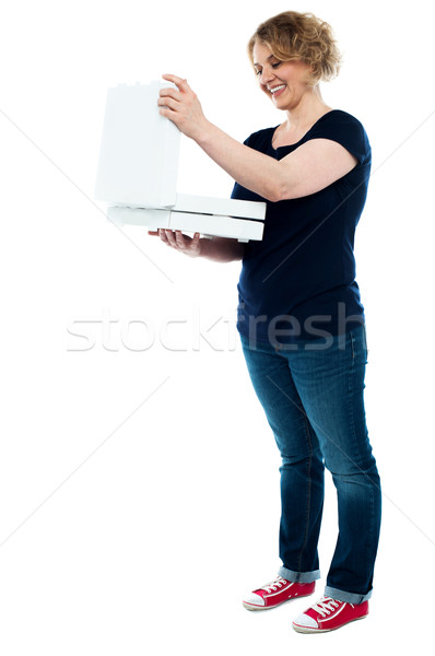 Beautiful woman looking into pizza box Stock photo © stockyimages