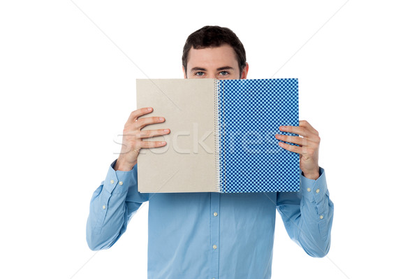 若い男 隠蔽 顔 ノートブック ハンサム 男 ストックフォト © stockyimages