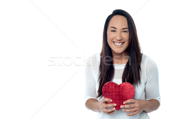 Smiling young woman hold red heart Stock photo © stockyimages