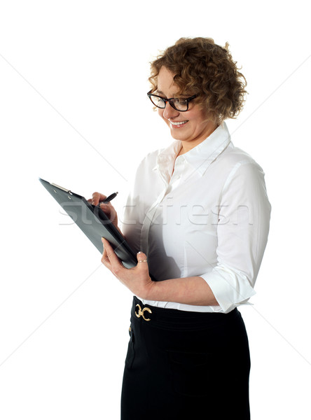 Female secretary writing business document Stock photo © stockyimages