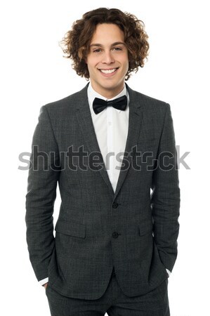 Young groom buttoning up his blazer Stock photo © stockyimages