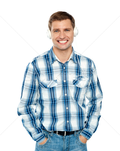 Casual caucasian guy listening to music Stock photo © stockyimages