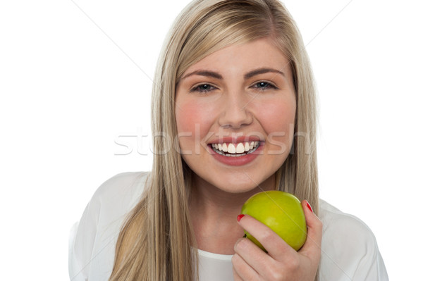 Health conscious girl holding green apple Stock photo © stockyimages