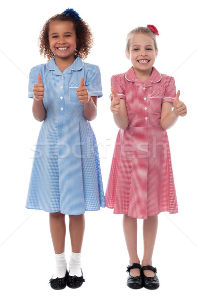 Cheerful girls showing double thumbs up Stock photo © stockyimages