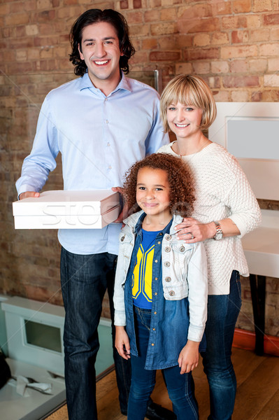 Little girl with parents posing casually Stock photo © stockyimages