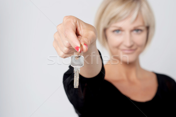 Szczęśliwy uśmiechnięta kobieta kluczowych szary Zdjęcia stock © stockyimages