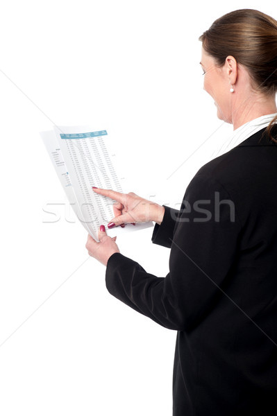 Back pose of businesswoman reading reports Stock photo © stockyimages