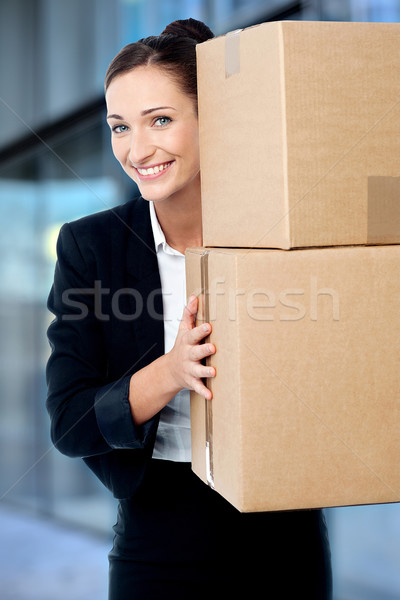 Female executive holding cardboard boxes Stock photo © stockyimages