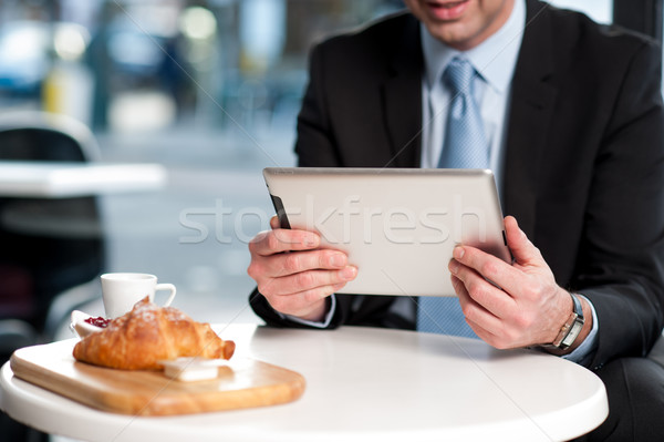 Handsome manager using his tablet device Stock photo © stockyimages