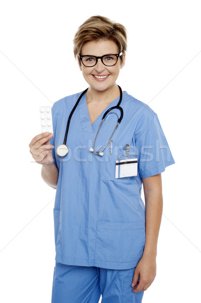 Doctor at duty holding medicine pack in hand Stock photo © stockyimages