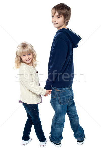 Delightful kids turning back and facing camera Stock photo © stockyimages